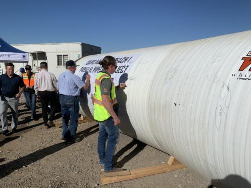 Stakeholders sign a piece of the Davis Aqueduct Reach 1 Parallel Pipeline during a press conference Wednesday, Oct. 2, 2024.