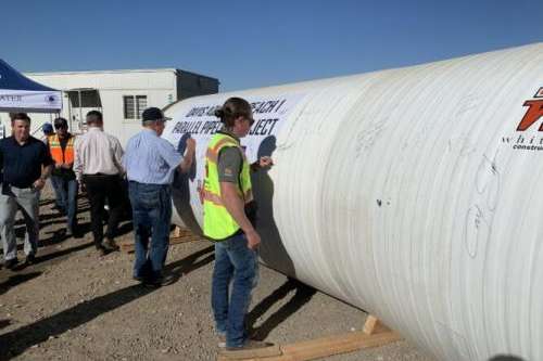 Stakeholders sign a piece of the Davis Aqueduct Reach 1 Parallel Pipeline during a press conference Wednesday, Oct. 2, 2024.