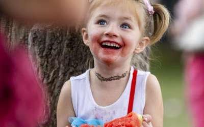 Aurora Tucker, 5, from Grand Junction, Colorado, laughs with a watermelon stained face while eating watermelon during the 118th annual Melon Days Festival in Green River on Saturday, Sept. 21, 2024. Tucker has been attending the Melon Days festival to enjoy watermelon for her entire life so far. Brice Tucker, Deseret News