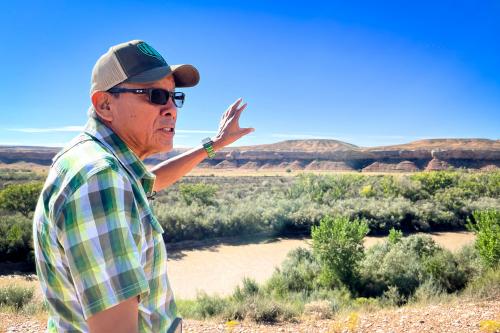 Mark Maryboy points across the San Juan River to where his family used to farm on the Navajo Nation in southeast Utah, Sept. 19, 2024. Credit: David Condos, KUER