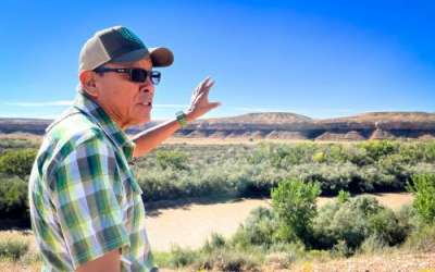 Mark Maryboy points across the San Juan River to where his family used to farm on the Navajo Nation in southeast Utah, Sept. 19, 2024. Credit: David Condos, KUER