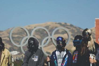 Utah teens wear gas masks and ski goggles at Olympic Cauldron Park during a demonstration in support of Great Salt Lake on Saturday, Oct. 26, 2024. The teens want to see Utah legislators do more to protect the lake. (Topaz Henderson/Utah Youth Environmental Solutions)