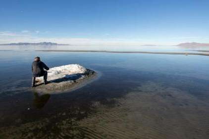 FILE --Mark Milligan, with the Utah Geological Survey, takes a photo of a mound formed by the mineral mirabilite on the shores of the Great Salt Lake on Tuesday, Jan. 7, 2020. (Scott G. Winterton/Deseret News)