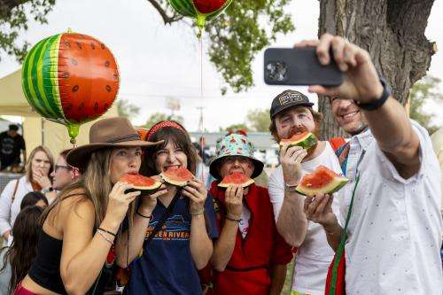 Caption: From right to left, Matt Beatty, Noah Myers, Vanessa Adams, Bella Beatty and Amy Beatty take a selfie eating watermelon during the 118th annual Melon Days Festival in Green River on Saturday, Sept. 21, 2024. The Beattys have been coming to Green River’s Melon Days Festival with family and friends for over a decade. | Brice Tucker, Deseret News