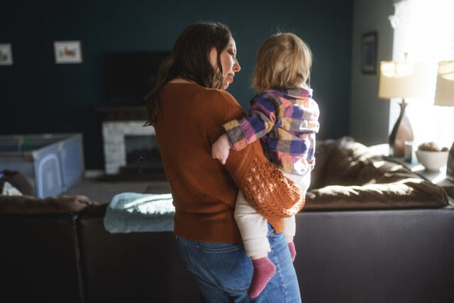 Stacia Ryder, Ph.D., an assistant professor of sociology at Utah State University, holds her 1-year-old daughter at their home in Ogden on Thursday, Jan. 22, 2026. (Photo by Spenser Heaps for Utah News Dispatch)